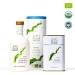 Juicy Olive Squezzid organic extra virgin olive oil set including a white bottle with a wooden cap, a white cylindrical tin with a blue lid, and a white rectangular can with a gold base, shown on a white background with USDA Organic and organic certification logos.